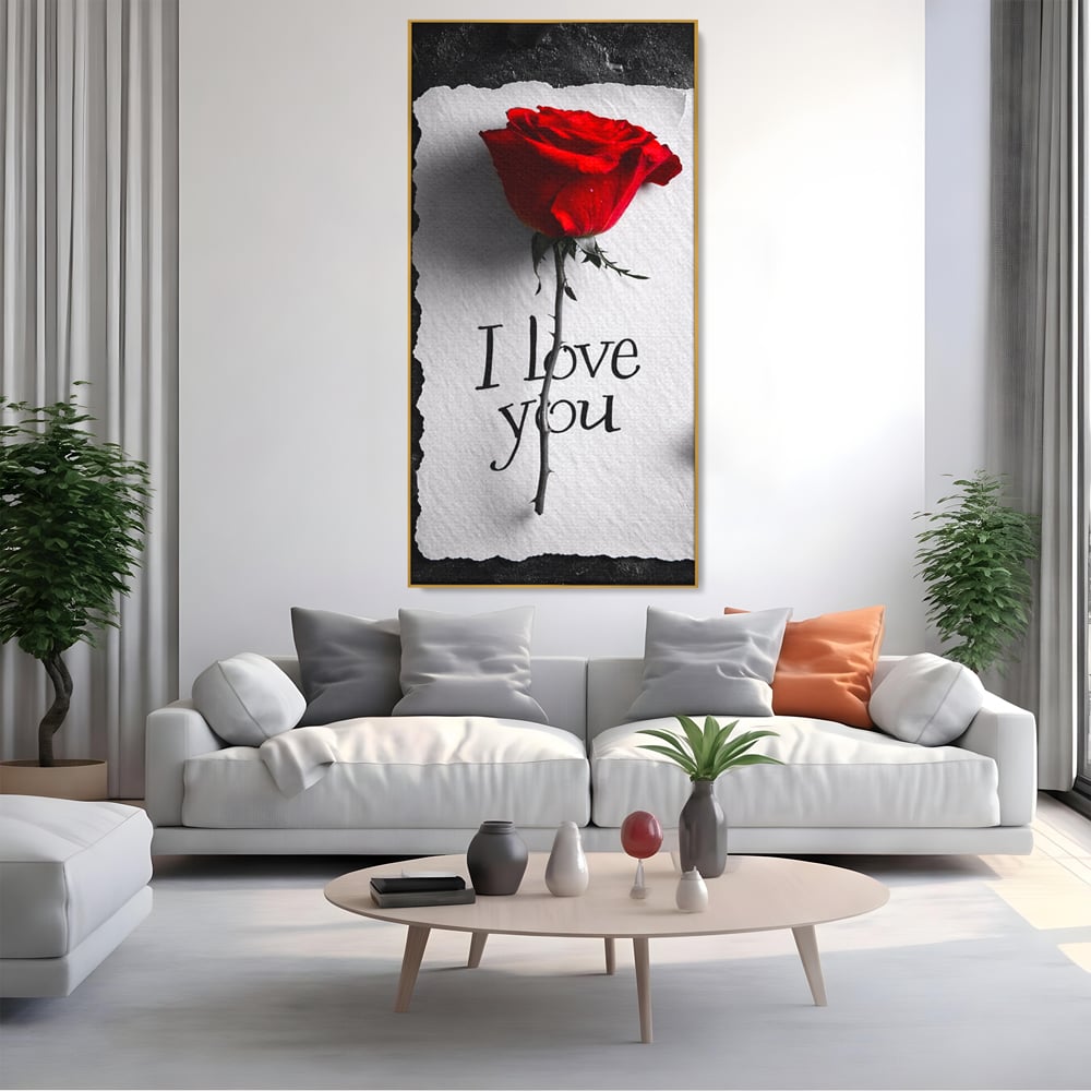 Tablou canvas cu tablou vertical cu trandafir rosu si mesaj, in rama de aluminiu auriu, pe perete intr-un living